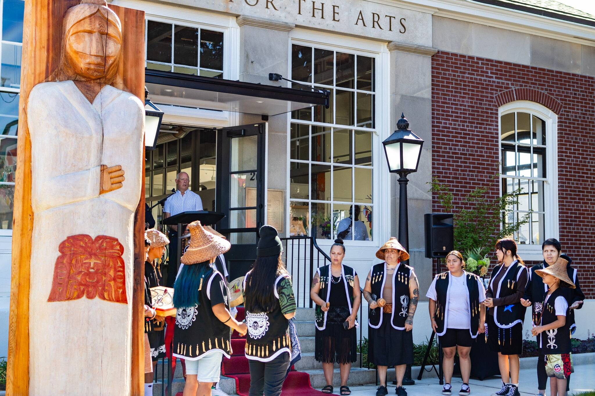 Photo courtesy of City of Auburn
The Muckleshoot Indian Tribe unveil their gift of a Welcome Figure and provide a song and blessing during the Postmark Center for the Arts grand opening. The figure was created by Muckleshoot artists Sam Obrovac, Tyson Simmons and Keith Stevenson.