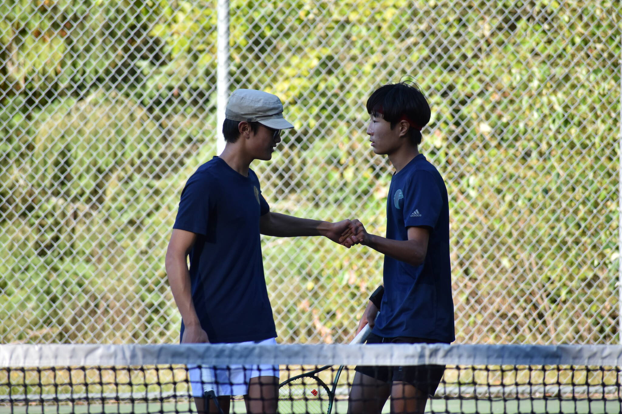 Caleb Choi and Allen Nguyen celebrate after winning a game in the second set. Ben Ray / The Reporter