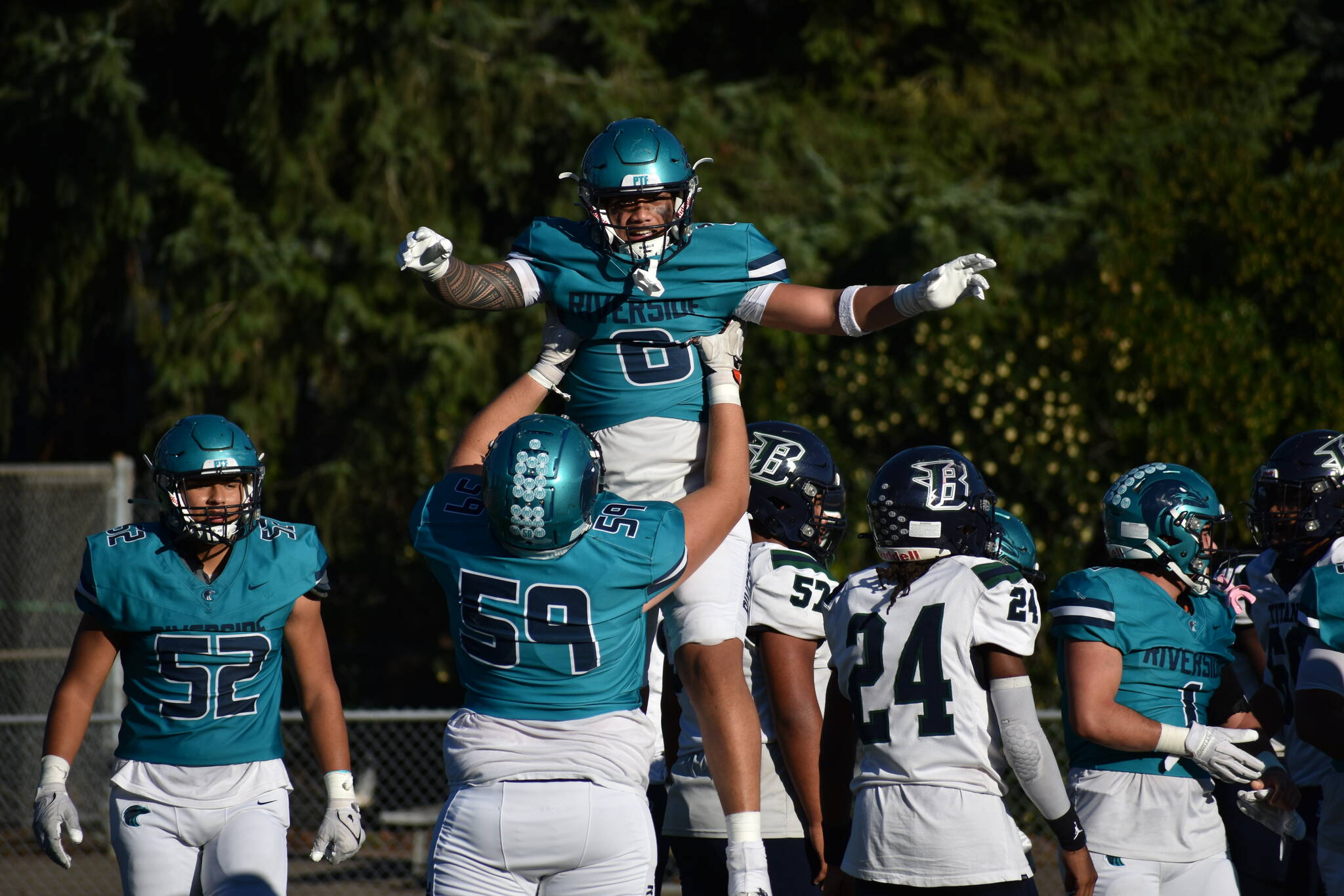 Thyrou Umi-Tuato’o is lifted up by Andrey Redka after a touchdown. Ben Ray / The Reporter
