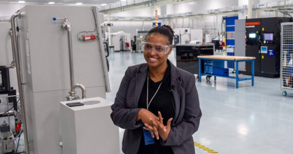 Magnificent Willis, a leader in Boeing product integration, welcomes AWB’s Manufacturing Week tour group Oct. 11 to the Boeing Additive Manufacturing metals print room in Auburn. COURTESY PHOTO, Brian Mittge/Association of Washington Business