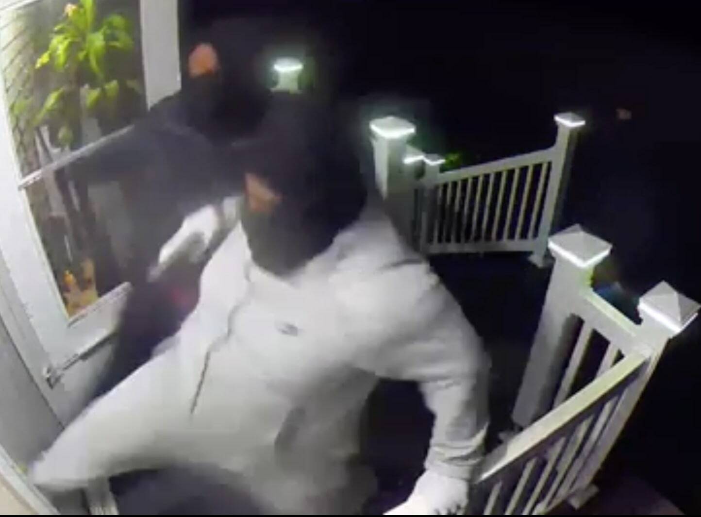 Screenshot of surveillance video that shows intruders trying to break into an Auburn residence.