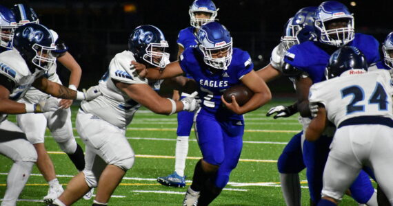 Federal Way’s Sione Kongaika stiff-arms a defender. (Ben Ray/Sound Publishing)