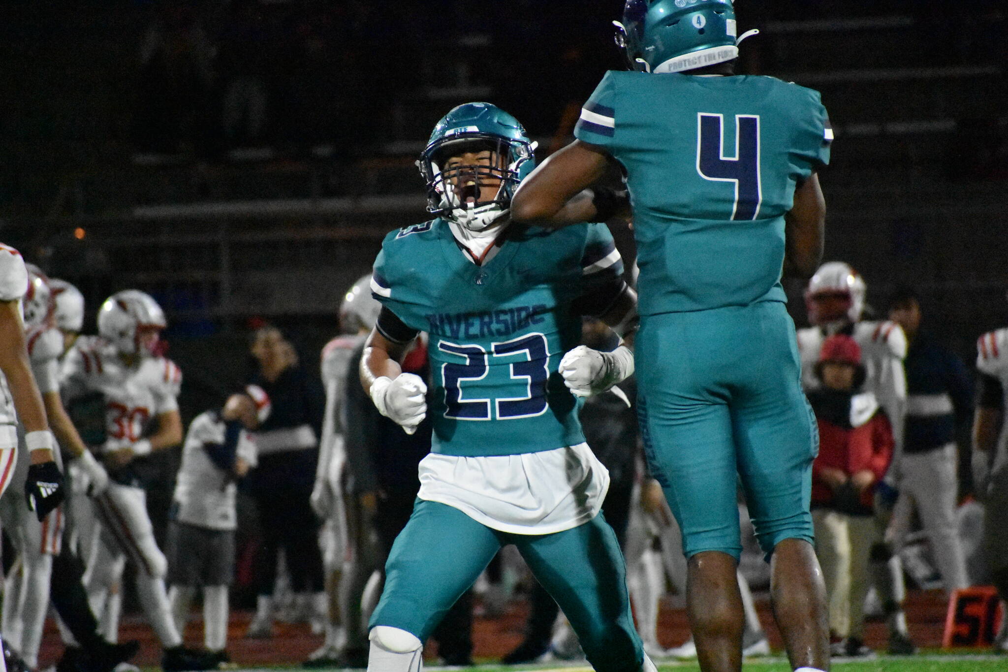 Jordan Hefa and Jonathan Epperson celebrate after a stop on defense. Ben Ray / The Reporter