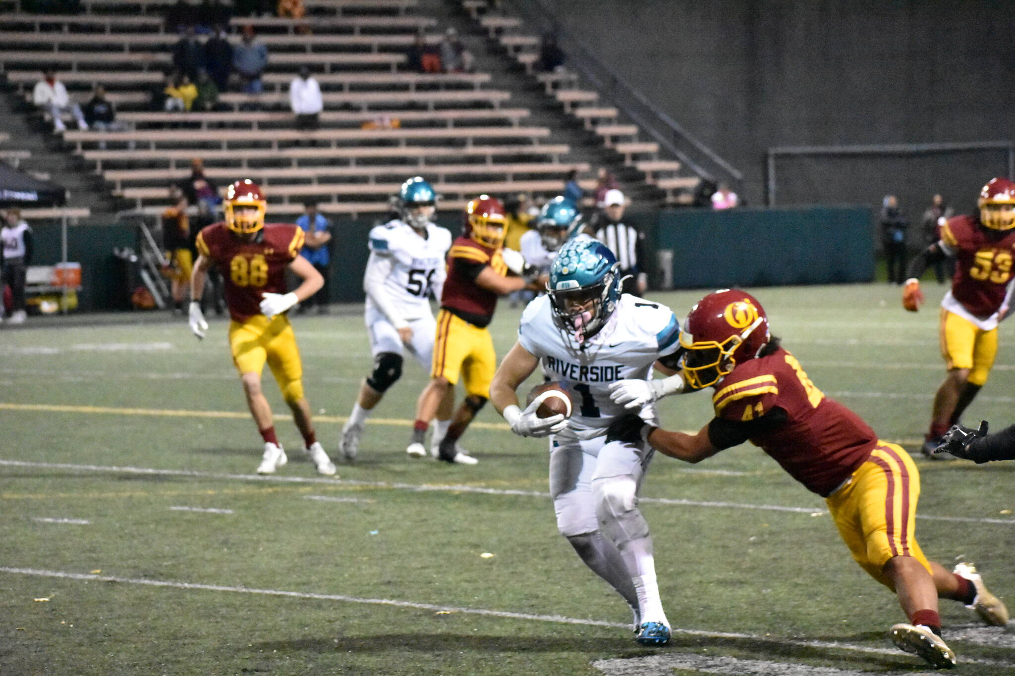 Andrew Shrader attempts to break a tackle against O’Dea. Ben Ray / The Reporter