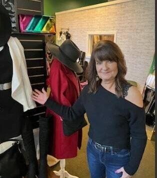 Heather Feller discusses some of the snappy clothes she has to sell at Emerald City Fashion, her clothing boutique at 50 West Main in downtown Auburn. Photo by Robert Whale, Auburn Reporter