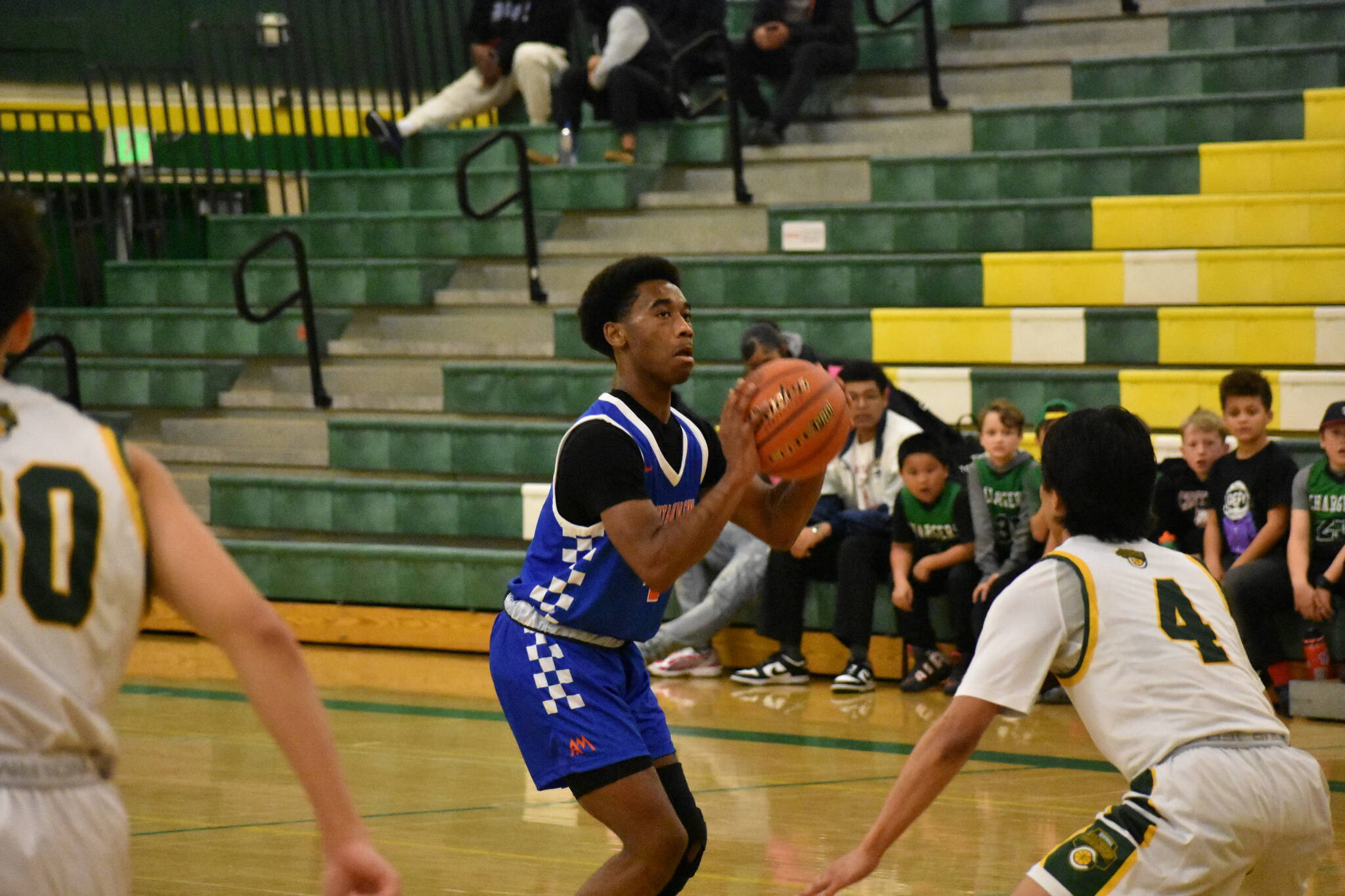 Senior Carmelo Jacobs takes a three pointer against Kentridge. (Photos by Ben Ray / The Reporter)