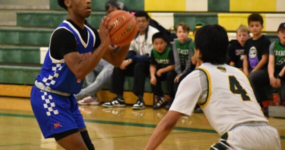 Senior Carmelo Jacobs takes a three pointer against Kentridge. Ben Ray / The Reporter