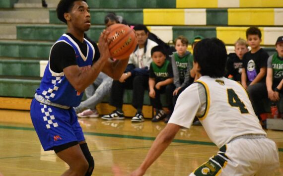 Senior Carmelo Jacobs takes a three pointer against Kentridge. Ben Ray / The Reporter