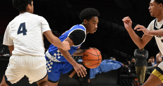 Auburn Mountainview High School’s boys basketball team played in the Court of Dreams invitational on Dec. 20 at the Moda Center in Portland. The Lions defeated Lindbergh High School, 68-43. Pictured: Melo Jacobs dribbles past a Lindbergh defender. (Photos by Ben Ray/The Reporter)