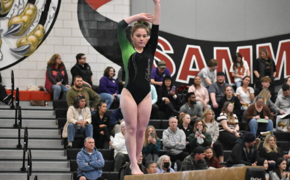 Auburn gymnast focuses in during her balance beam routine at Sammamish High School. Ben Ray / The Reporter