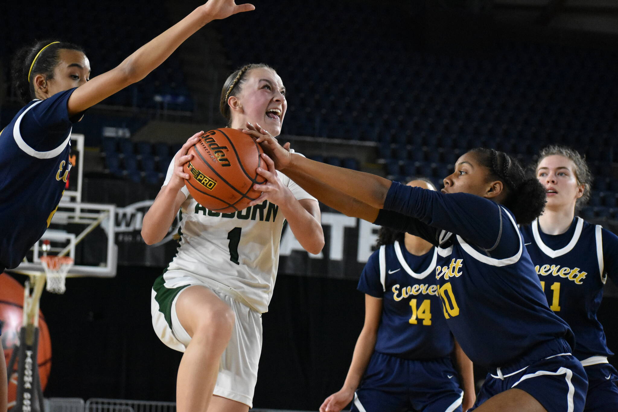 Avery Hansen goes up for a lay-up and fights through contact on her way to the rack against Everett. Ben Ray / The Reporter