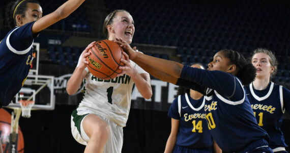 Avery Hansen goes up for a lay-up and fights through contact on her way to the rack against Everett. Ben Ray / The Reporter