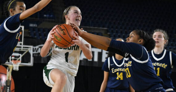 Avery Hansen goes up for a lay-up and fights through contact on her way to the rack against Everett. Ben Ray / The Reporter