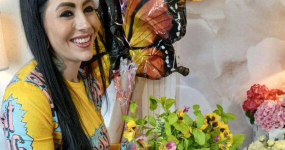 Assistant Jamie Stephens with some of the floral arrangements she has put together at White Willow Company in the Auburn Arcade. Photo by Robert Whale/Auburn Reporter