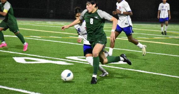 Jesus Magana takes the ball up the field for the Trojans. Ben Ray / The Reporter