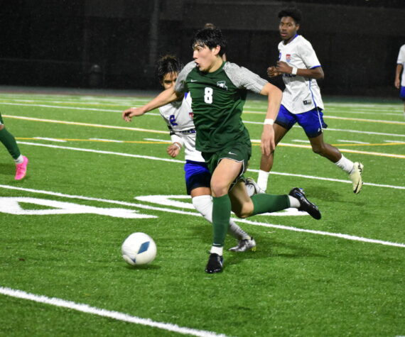Jesus Magana takes the ball up the field for the Trojans. Ben Ray / The Reporter