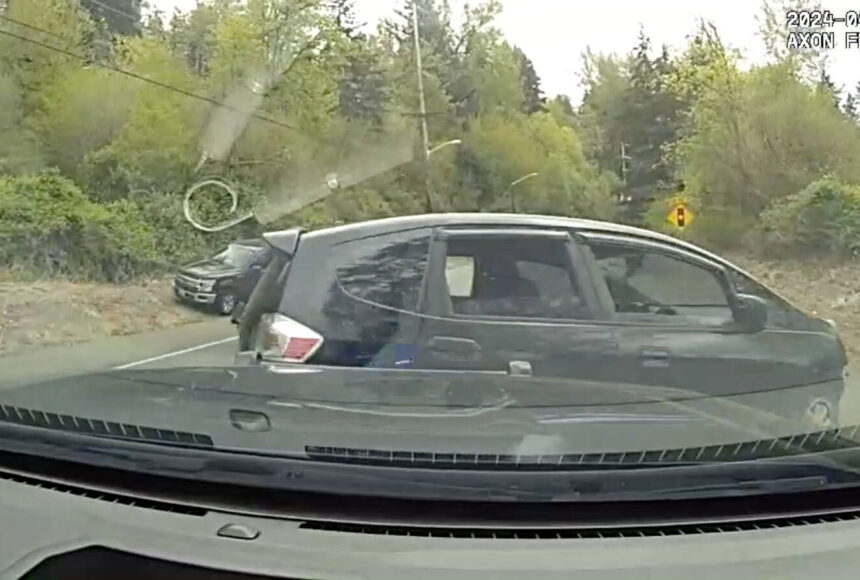 <p>A pursuing officer deployed a PIT maneuver on the Honda Fit, resulting in the vehicle turning sideways onto the side of the road. (Screenshot.)</p>