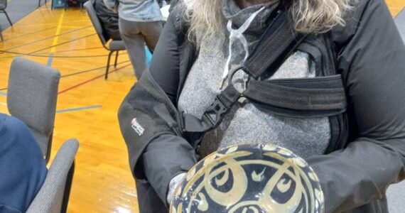 Nancy Peterson displays the bowl she took home from the Empty Bowls event April 26 at Grace Community Church in Auburn. Photo by Robert Whale/Auburn Reporter