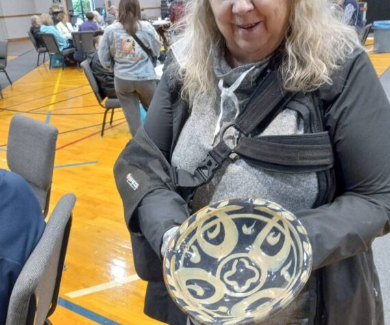 Nancy Peterson displays the bowl she took home from the Empty Bowls event April 26 at Grace Community Church in Auburn. Photo by Robert Whale/Auburn Reporter