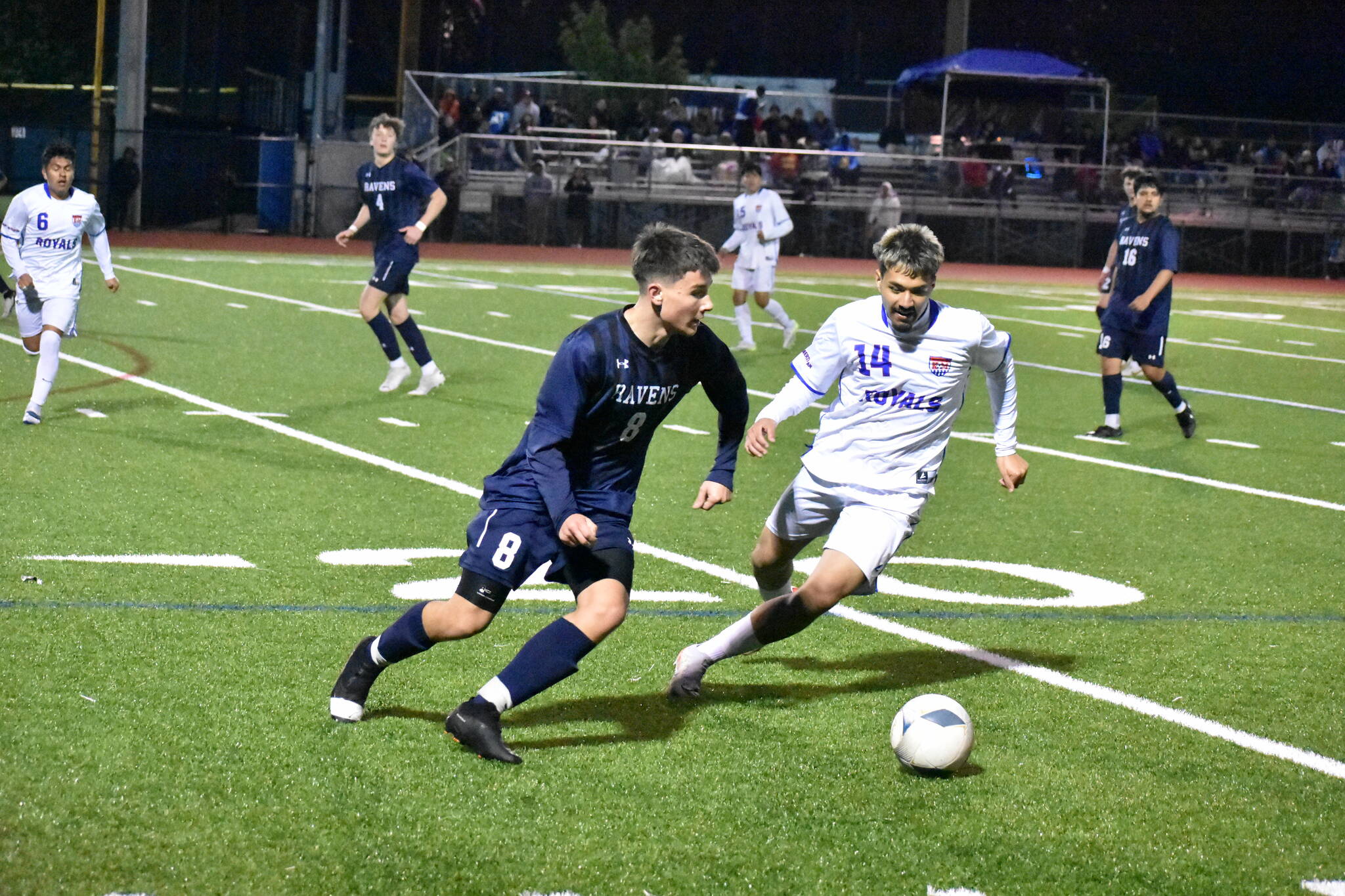 Auburn Riverside’s Luke Sullivan looks to control the ball and find a teammate with a defender closing in. Photos by Ben Ray / The Reporter