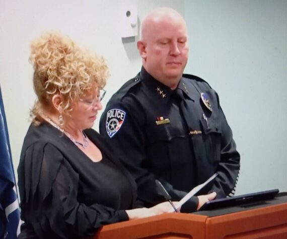 Mayor Nancy Backus commemorates Auburn Police Chief Mark Caillier’s 30 years of service. Photo by Robert Whale/Auburn Reporter
