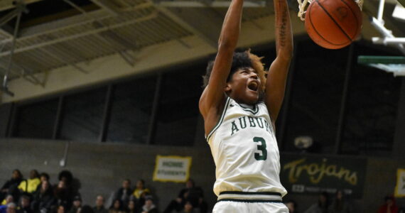 Jaylen Petty dunks early in the season for the Trojans. Ben Ray / The Reporter