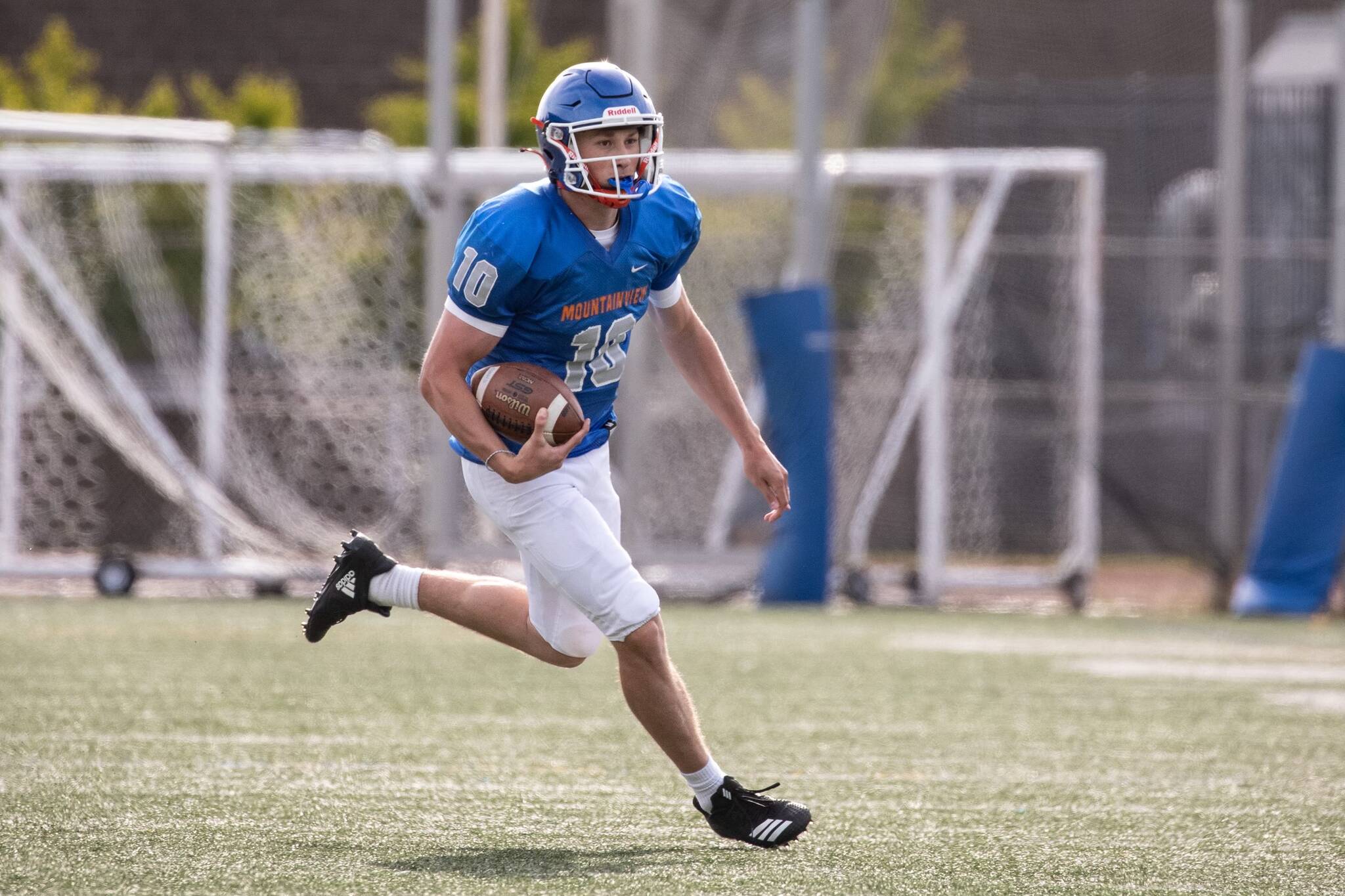Elijah Baird runs the ball during the Lions scrimmage at Curtis High School. Photo provided by Maria Dorsten.