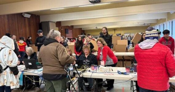 Auburn Food Bank Director Debbie Christian and Auburn Mayor Nancy Backus at the Dec. 23 annual Christmas distribution of food boxes for local people and families in need in the Fellowship Hall at Holy Family Catholic Church. Courtesy photo, City of Auburn.
