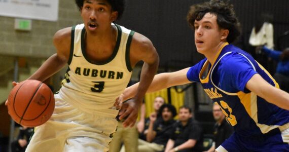 Trojan junior Daniel Johnson drives to the basket. Ben Ray / The Reporter
