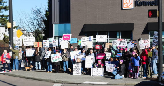 Fifty protesters held up a variety of signs at the Renton location for the Jan. 18, 2024 Women’s March and People’s March. Photo by Bailey Jo Josie/Sound Publishing.