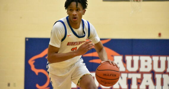 Lion senior Sebastian Arius drives towards the hoop against Enumclaw. Ben Ray / The Reporter