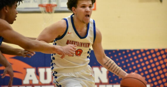 Lucas McClendon fights off a defender. Ben Ray / The Reporter