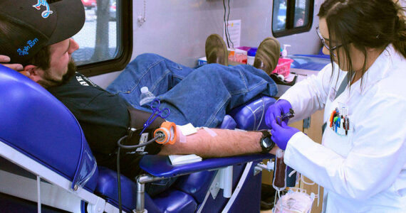 A mobile center from Bloodworks Northwest takes blood from Enumclaw resident Andy Bremmeyer, pictured in this 2019 photo. Sound Publishing file photo