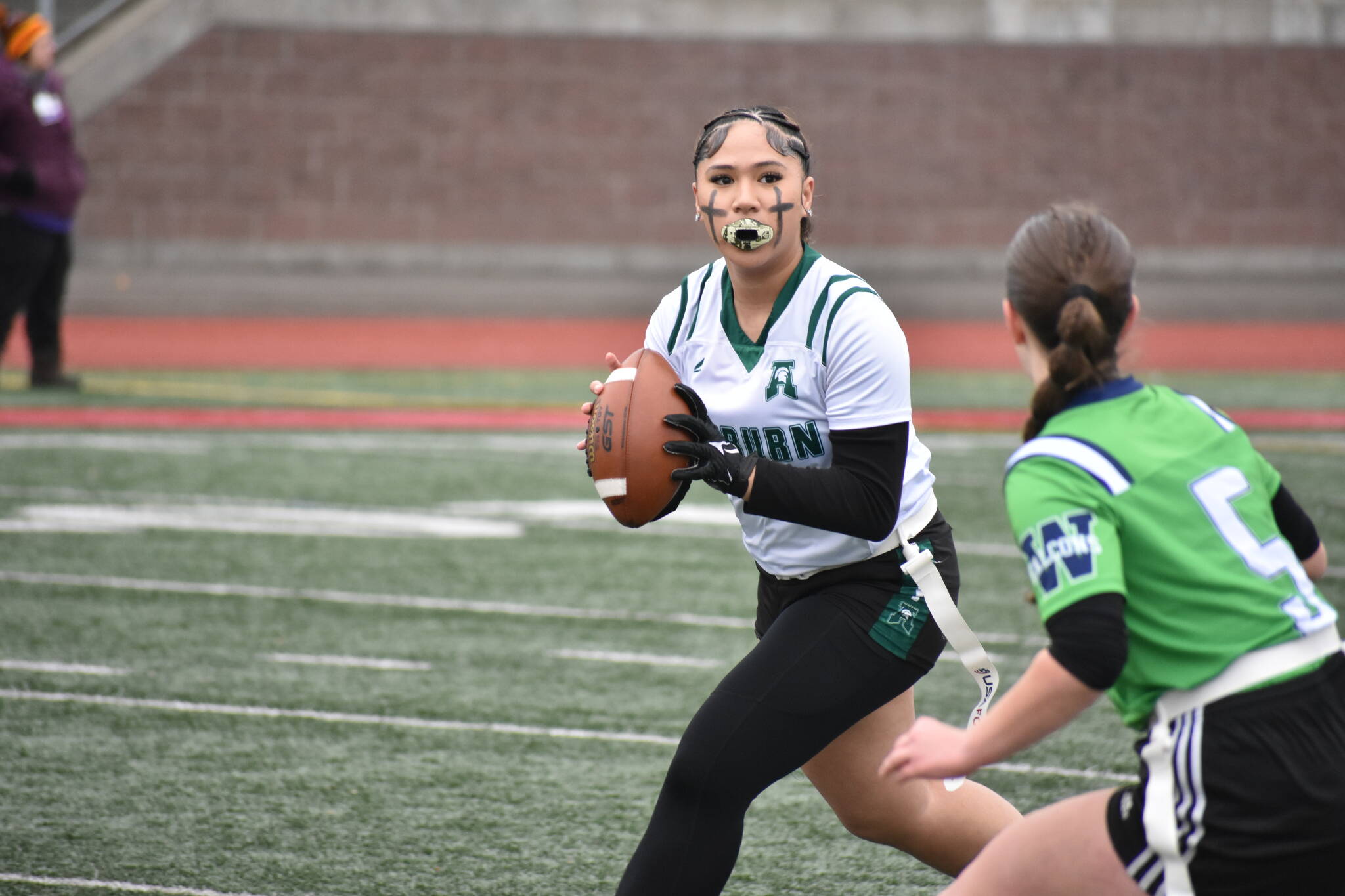 Fele Gasetoto rolls out of the pocket looking for a receiver. Ben Ray / The Reporter