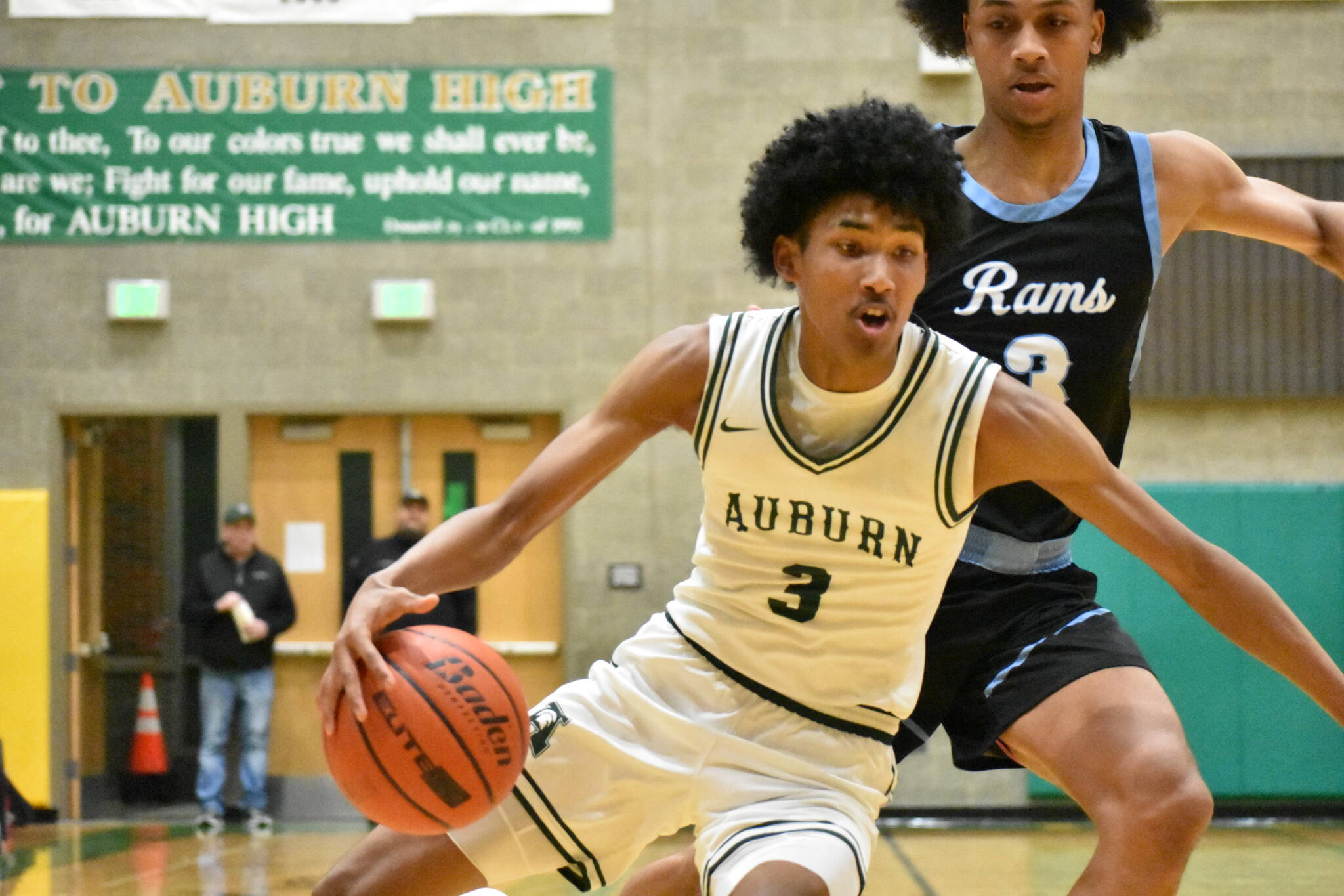 Daniel Johnson sneaks past a Rogers defender in the district tournament. Ben Ray / The Reporter