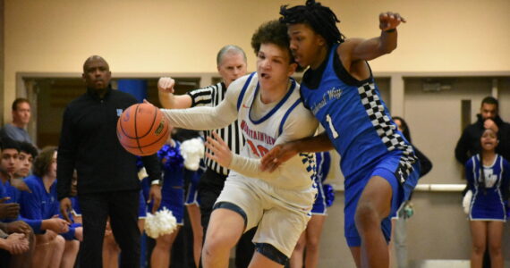 Lucas McClendon battles a Federal Way player down the court. Ben Ray / The Reporter