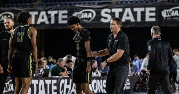 Head Coach Ryan Hansen consoling Daniel Johnson. Photo by Maria Dorsten