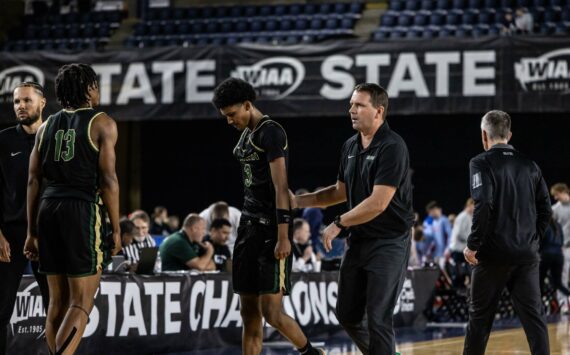 Head Coach Ryan Hansen consoling Daniel Johnson. Photo by Maria Dorsten