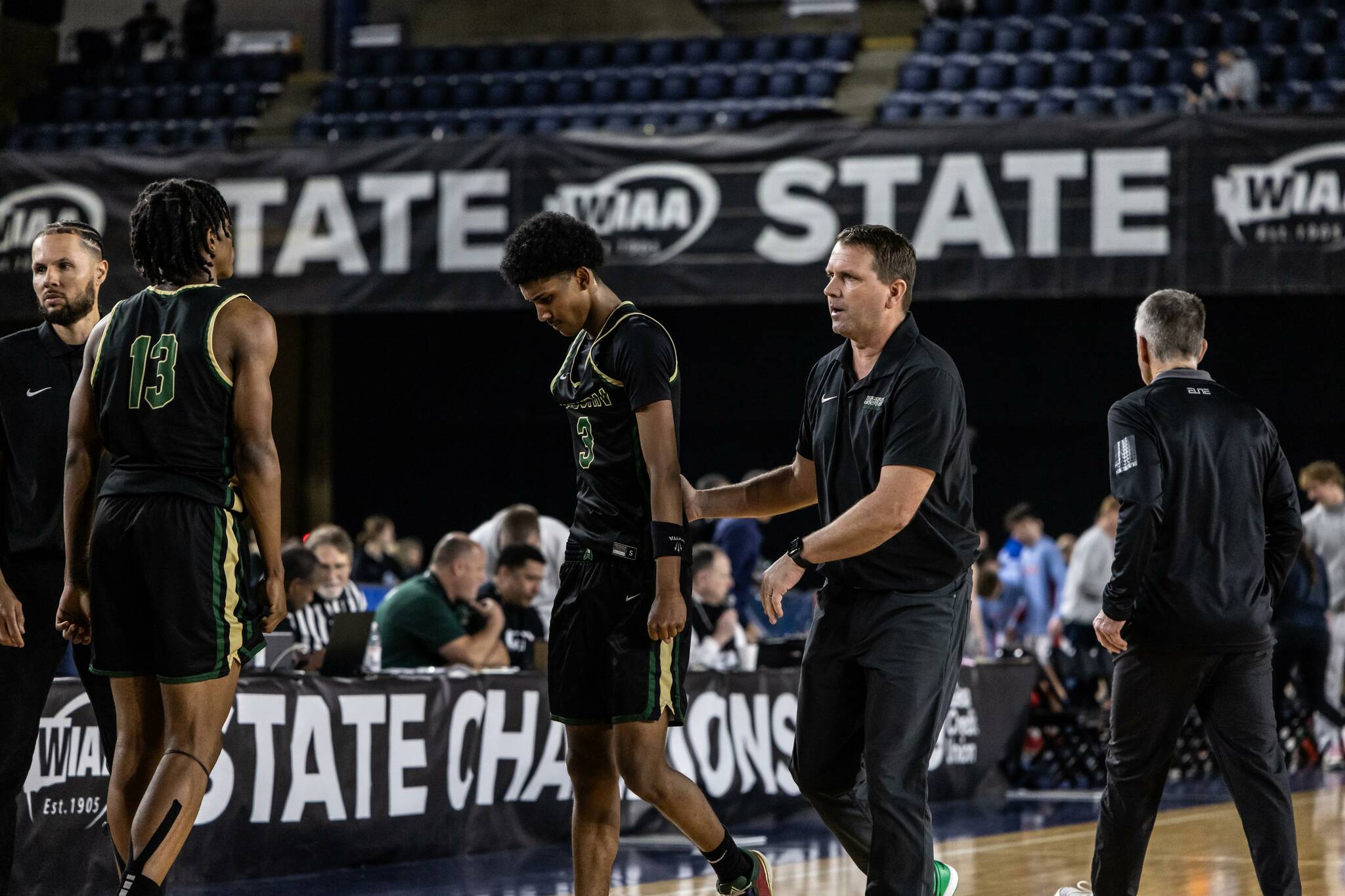 Head Coach Ryan Hansen consoling Daniel Johnson. Photo by Maria Dorsten