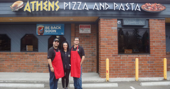 Pictured left to right: Bill, Nina and Tom Contoravdis, co-owners of Athens Pizza and Pasta, pose for a photo in front of their restaurant. File photo