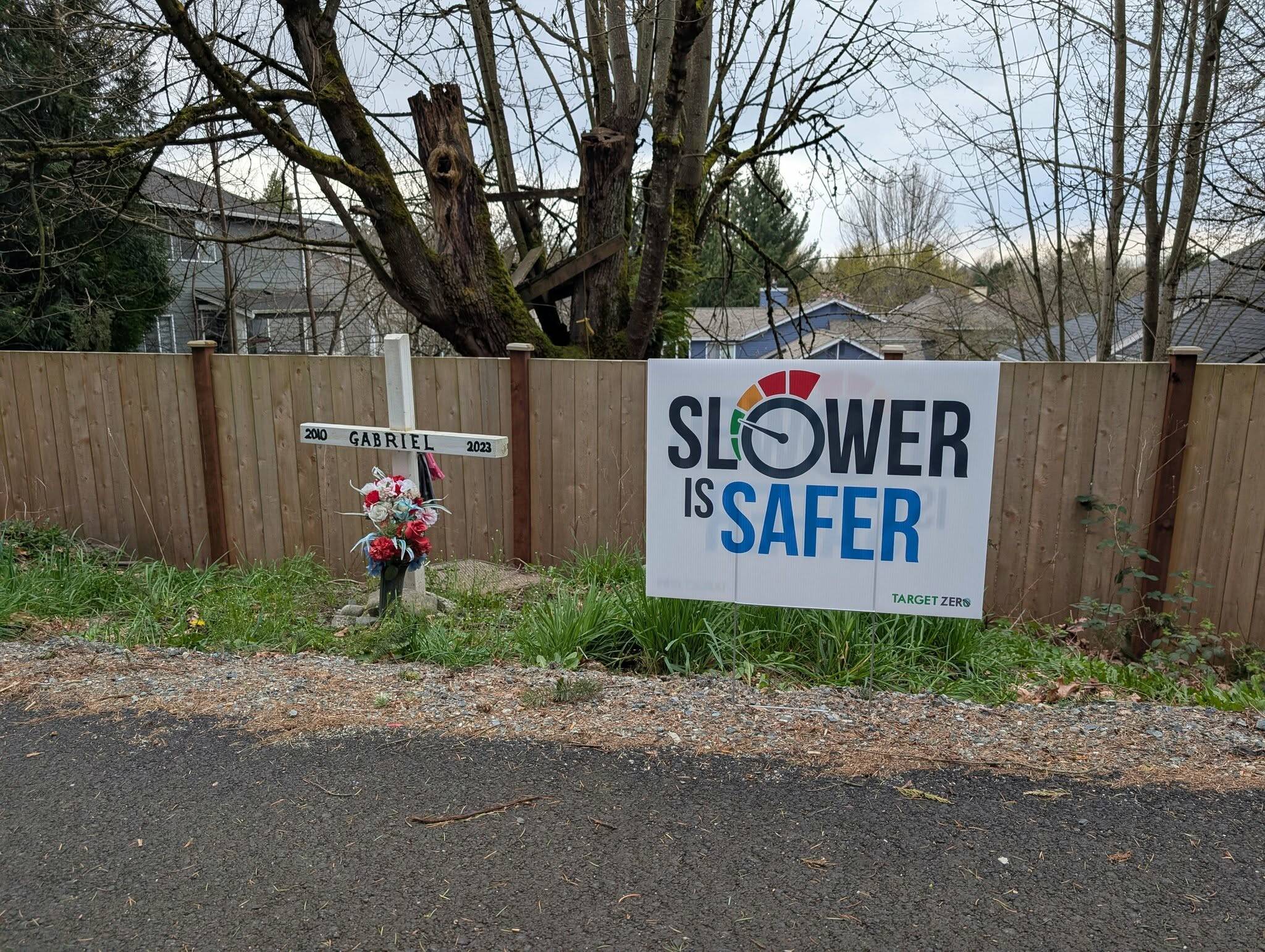 The Coury family placed their “Slower is safer” yard sign near the roadside memorial dedicated to their son, Gabriel, who was hit by a speeding drunk driver in 2023. Photo courtesy of Shellie Coury.