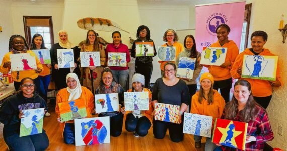 Painting the Mother Africa logo for the organization’s 2025 Board Retreat. Courtesy photo.