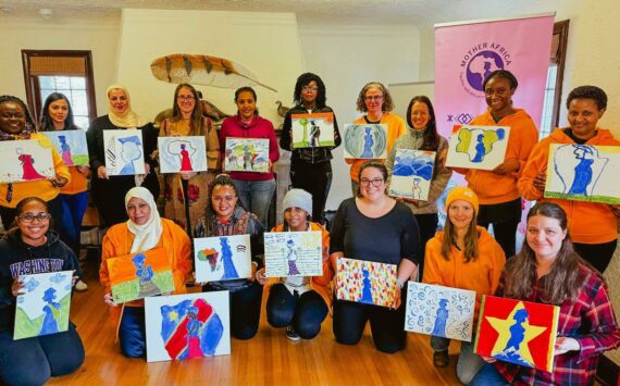 Painting the Mother Africa logo for the organization’s 2025 Board Retreat. Courtesy photo.
