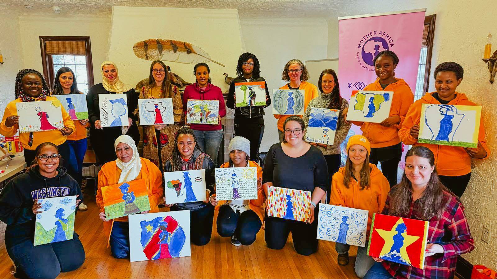Painting the Mother Africa logo for the organization’s 2025 Board Retreat. Courtesy photo.
