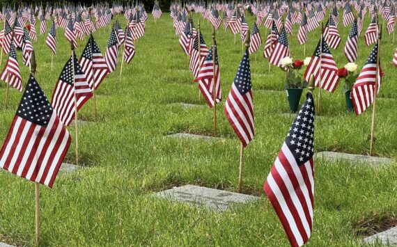 Small American flags adorn headstones at Tahoma National Cemetery in Kent. Photo Courtesy of Tahoma National Cemetery.