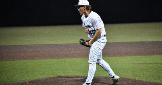 Cameron Bain lets a yell after ending the game against Kentwood. Ben Ray / The Reporter