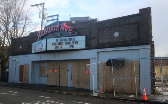 The Auburn Avenue Theater sits vacant and boarded up on Jan. 3, 2022, after being condemned due to safety concerns stemming from the demolition of the Max House Apartments complex next door. File photo