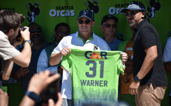 David Warner holds up his jersey for the Seattle Orcas. Ben Ray / The Reporter
