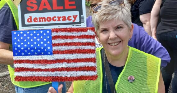 Vicki Bates, a former employee of the Auburn School District, at the No Kings protest. Photo by Robert Whale/Auburn Reporter