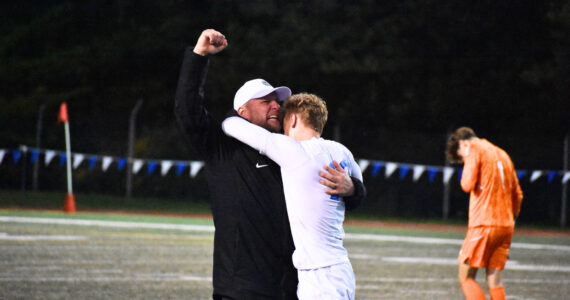Manager Joey West and Fedina celebrate the 3-2 win over Shorewood. Ben Ray / The Reporter
